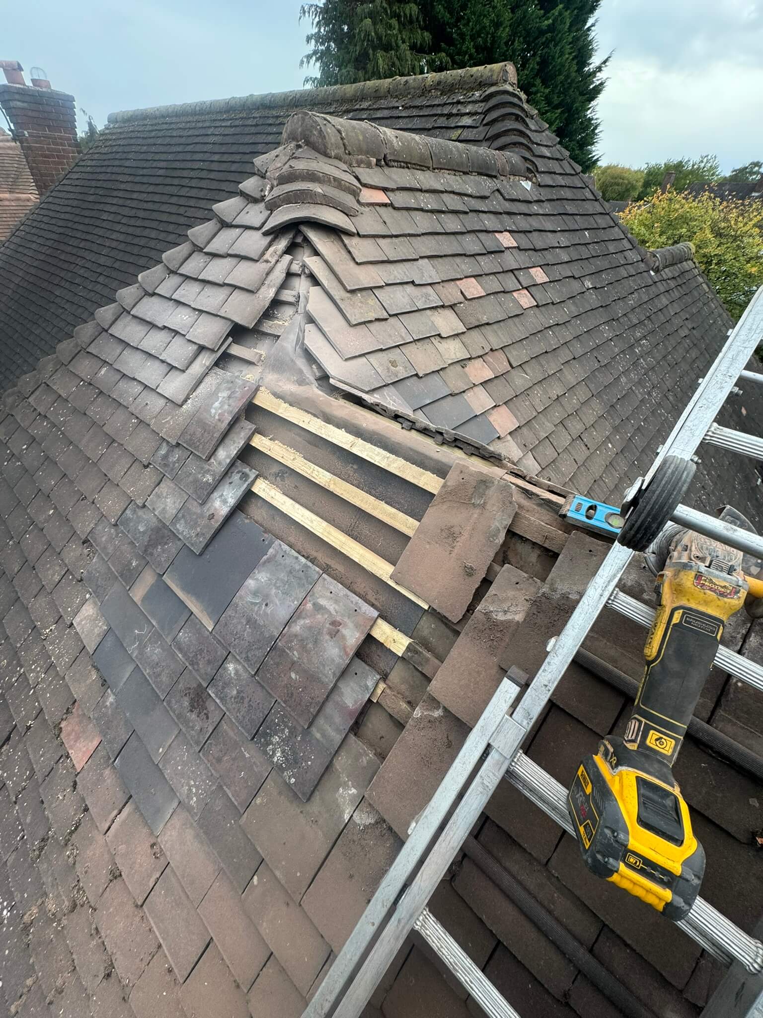 Tiled_Roof_Repair_Ridge_Hip_Installation_Your_Space_Innovations_Roofing_&_Building_Services_Ltd Ridge and hip tiles being installed on a tiled roof