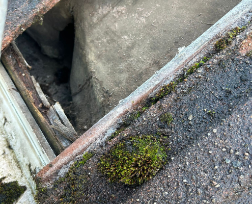 Close-up of deteriorated roof underlay beneath tiles Close-up roof inspection showing deteriorated underlay beneath lifted roof tiles